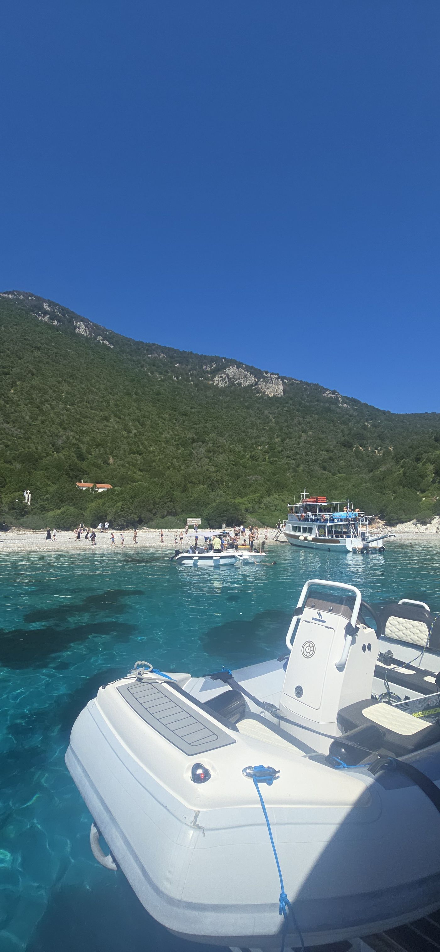 Catamaran anchored beside a cove with beach